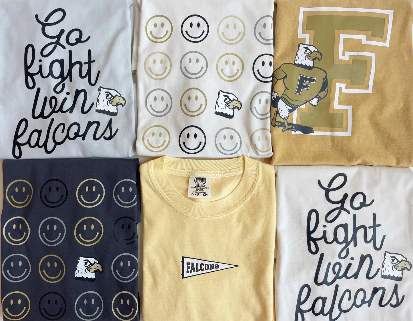 six school spirit shirts in yellow gold black cream and grey with go fight win falcons a falcon pennet and smiley faces 